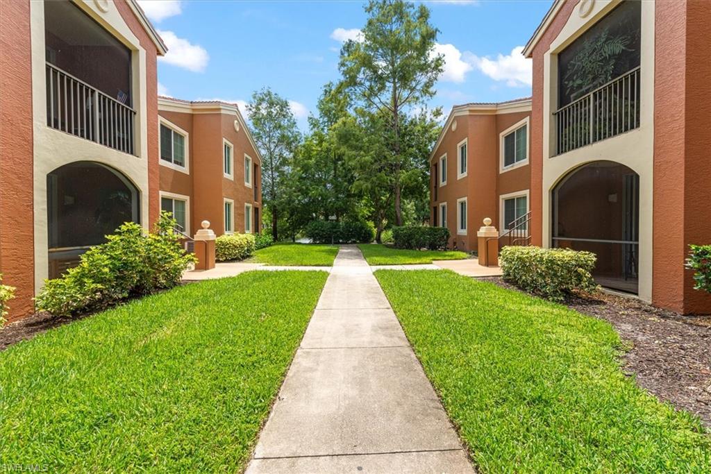 1170 Reserve Way, Unit 107 Naples, FL 34105 - Photo 46 of 47 View of community with a lawn and a residential view