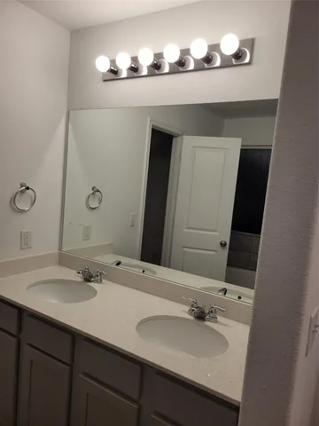 a white toilet sitting next to a white wall