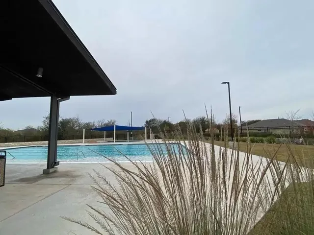 a view of a deck with a floor to ceiling window and a yard