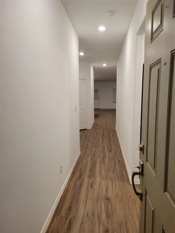a view of a room with wooden floor and staircase