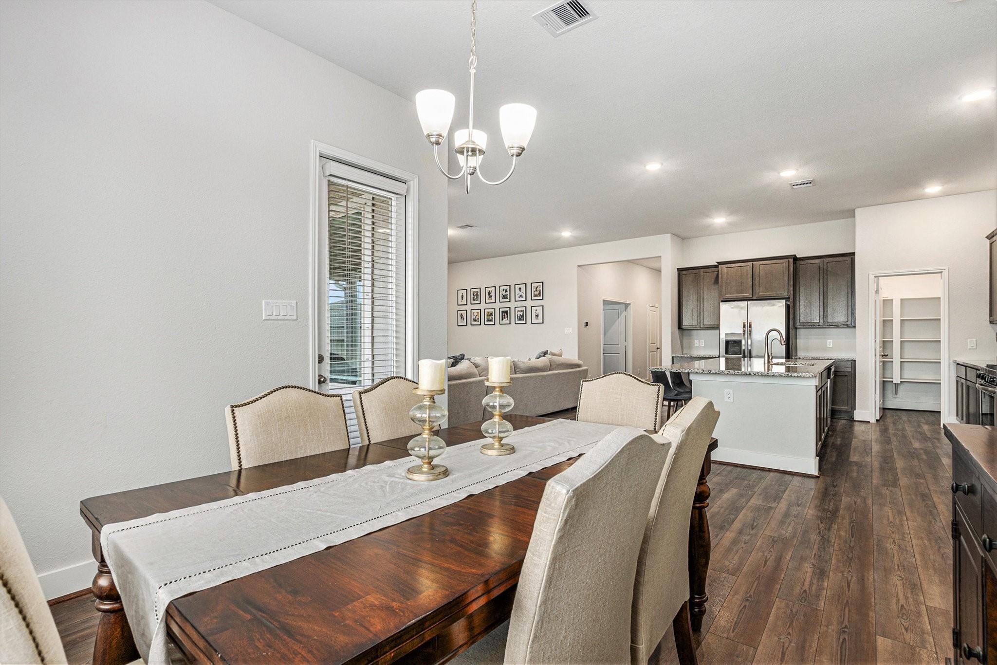 1818 Homewood Point Lane Rosharon, TX 77583 - Photo 13 of 41 a view of a dining room with furniture and wooden floor