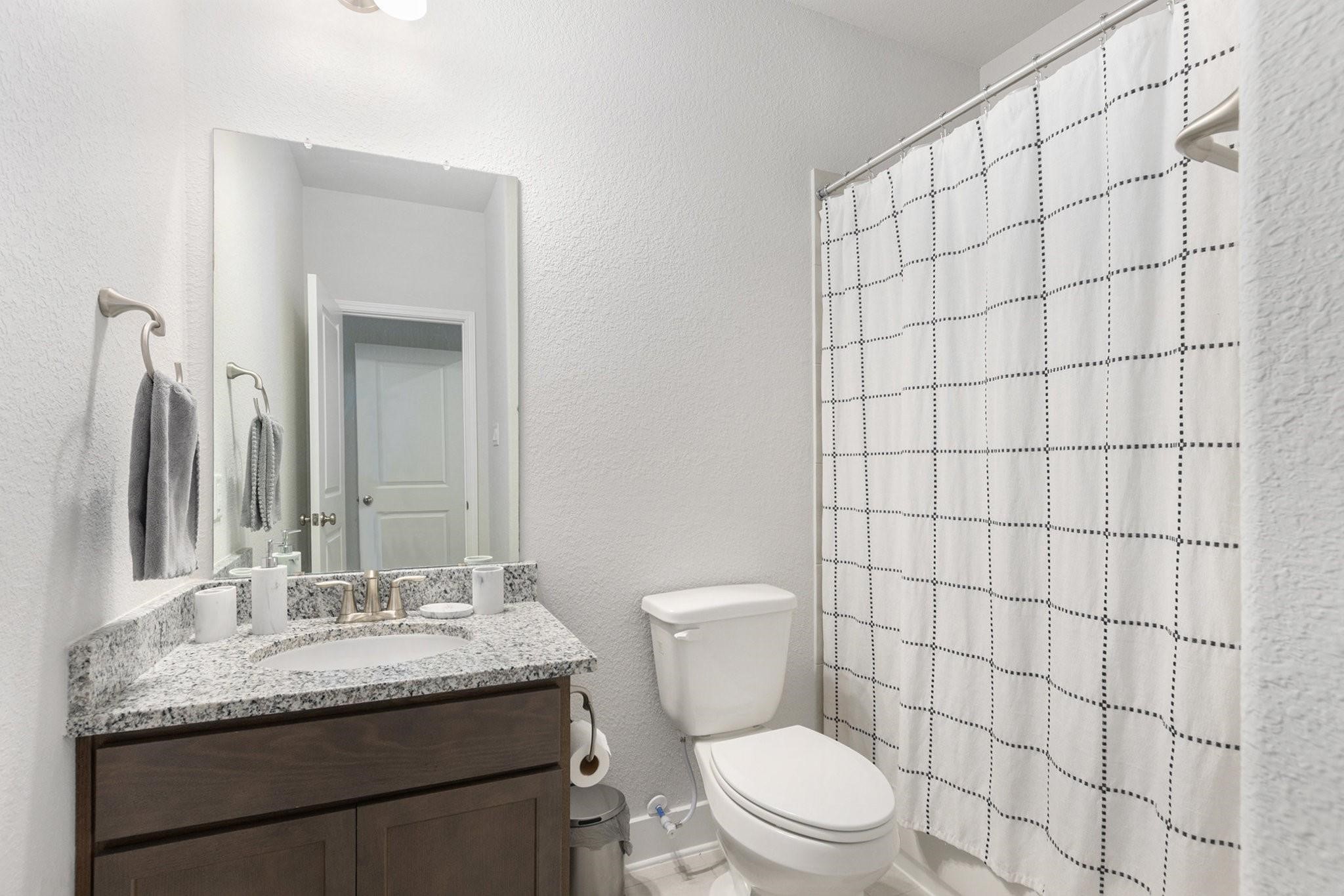 1818 Homewood Point Lane Rosharon, TX 77583 - Photo 18 of 41 a bathroom with a granite countertop sink a toilet and a mirror