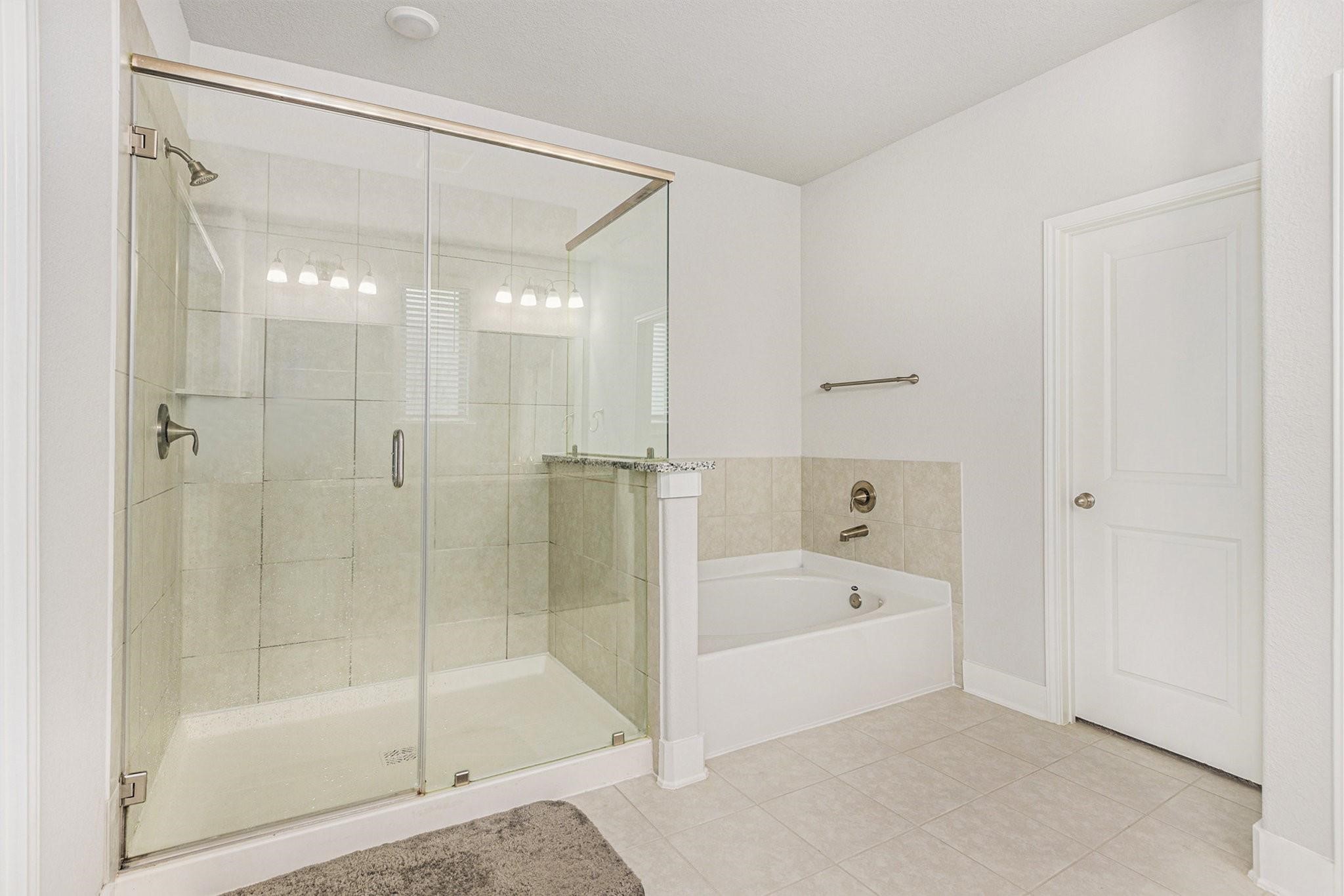 1818 Homewood Point Lane Rosharon, TX 77583 - Photo 22 of 41 a bathroom with a bathtub and a shower