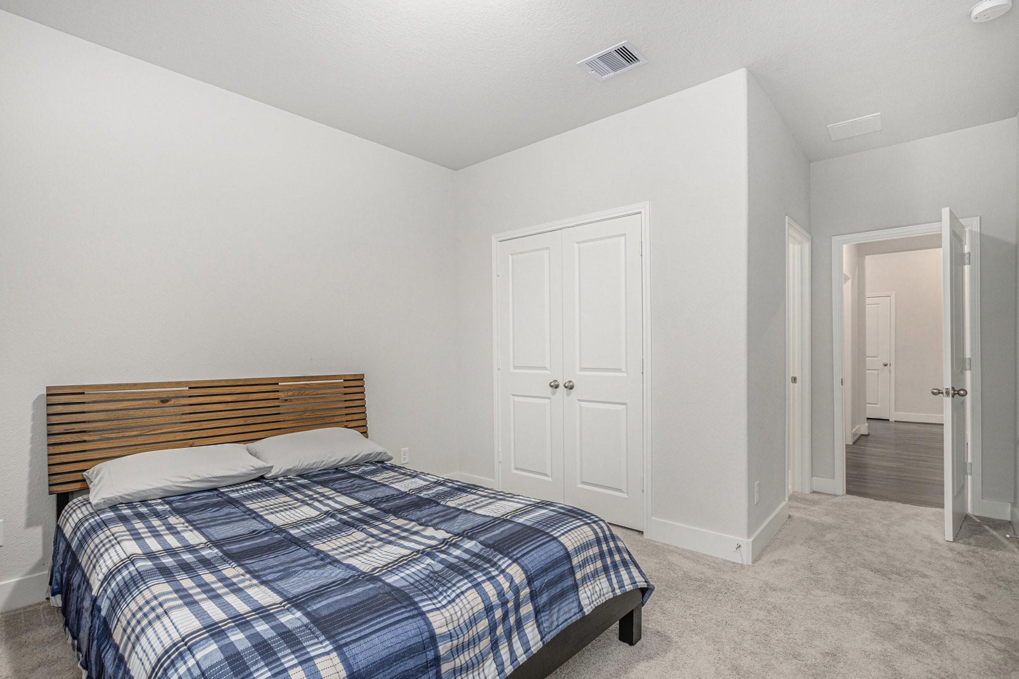 1818 Homewood Point Lane Rosharon, TX 77583 - Photo 24 of 41 a bedroom with a bed and a walk in closet