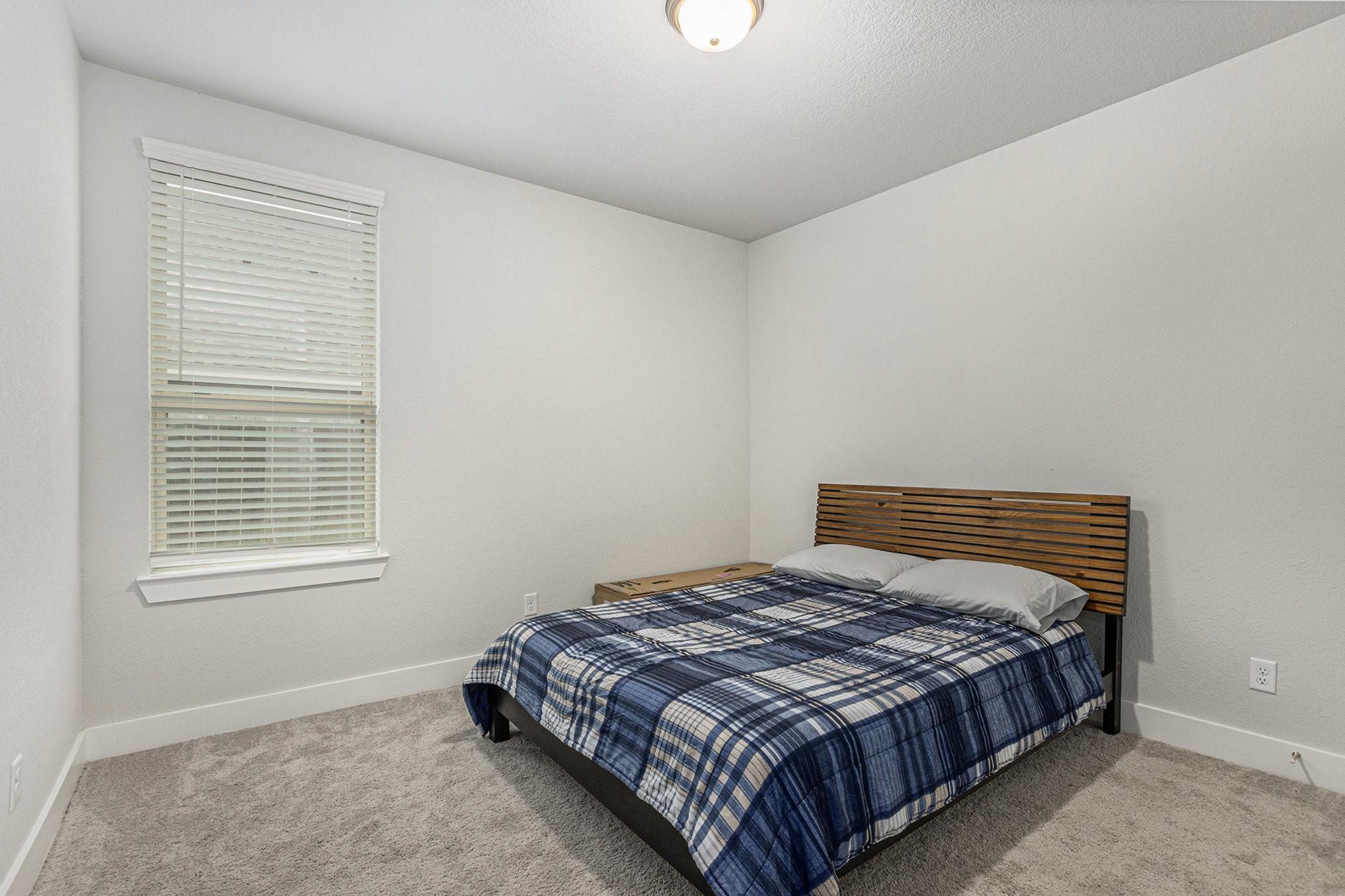 1818 Homewood Point Lane Rosharon, TX 77583 - Photo 25 of 41 a bedroom with a bed and a window