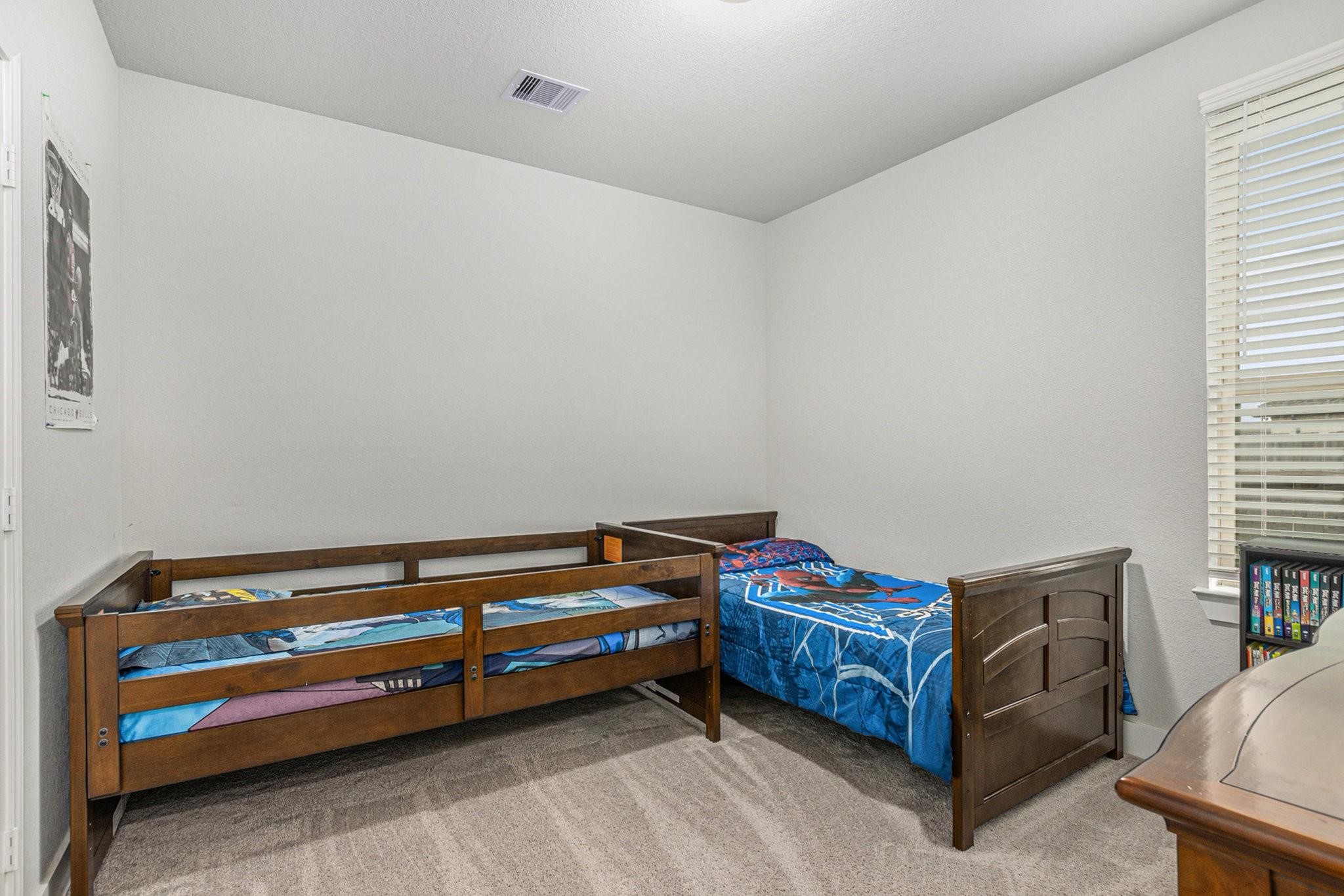1818 Homewood Point Lane Rosharon, TX 77583 - Photo 26 of 41 a room with a bed and a dresser