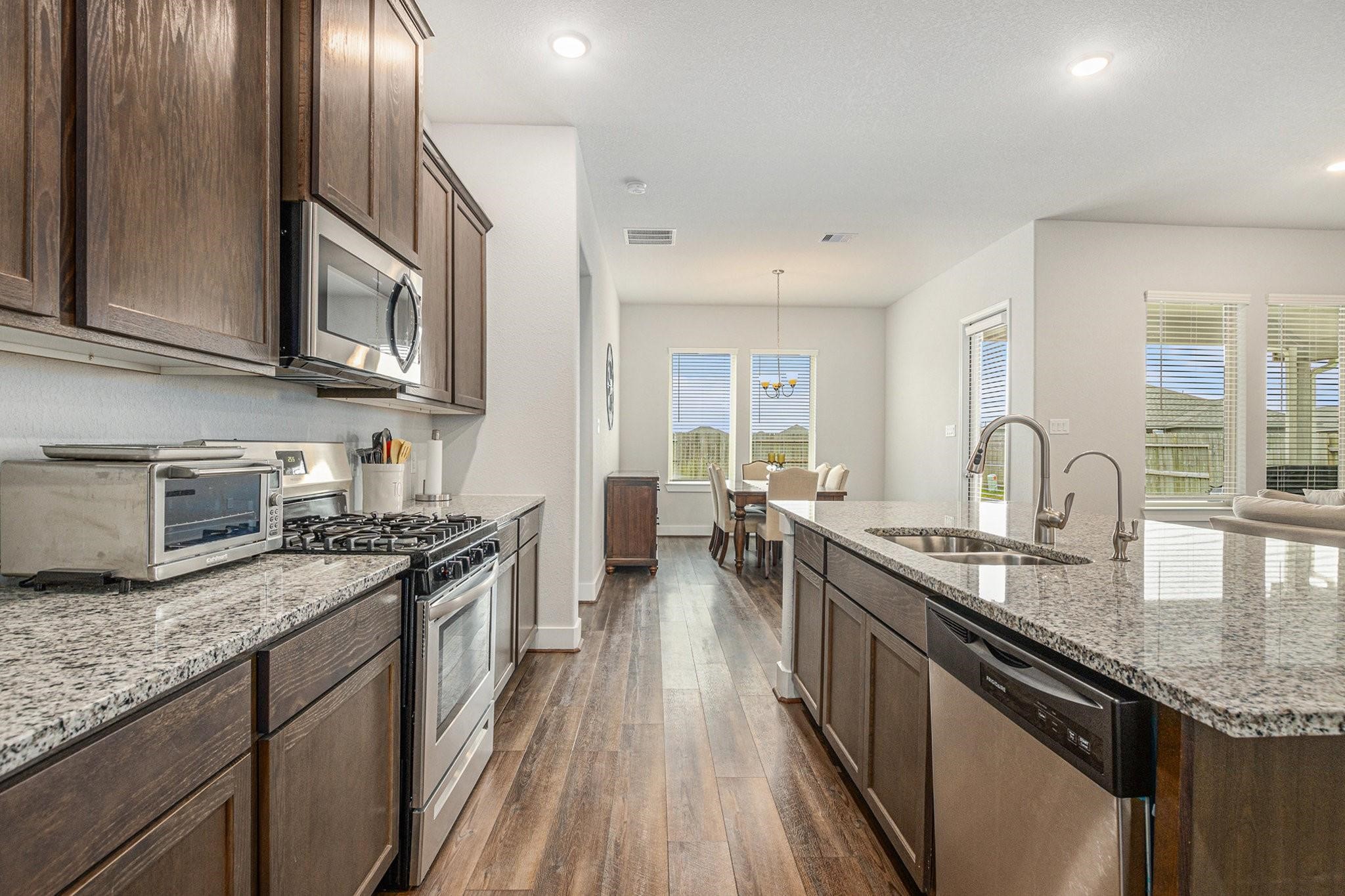 1818 Homewood Point Lane Rosharon, TX 77583 - Photo 8 of 41 a kitchen with granite countertop stainless steel appliances and wooden cabinets