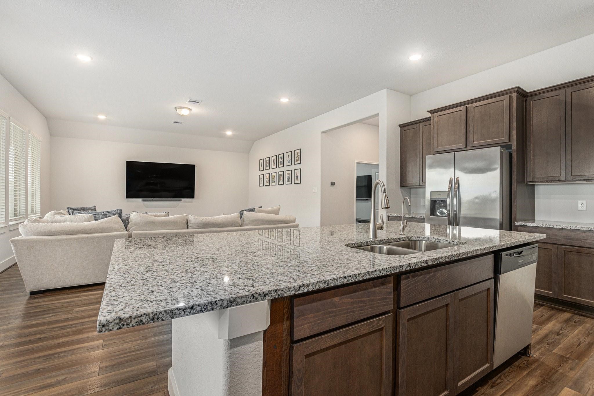 1818 Homewood Point Lane Rosharon, TX 77583 - Photo 10 of 41 a kitchen with stainless steel appliances kitchen island granite countertop a sink and a refrigerator