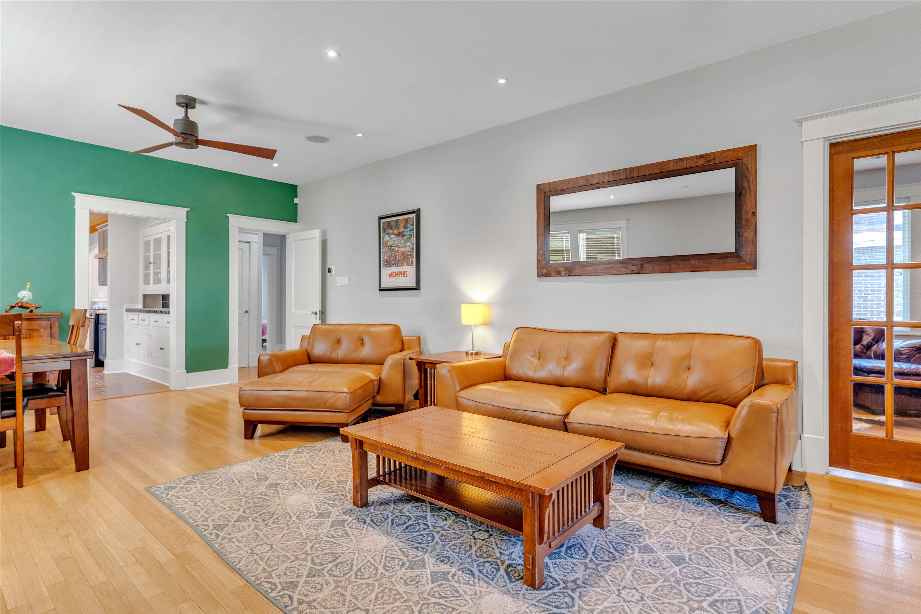 1757 Carruthers Place Memphis, TN 38112 - Photo 13 of 40 a living room with furniture a rug and a wall painting