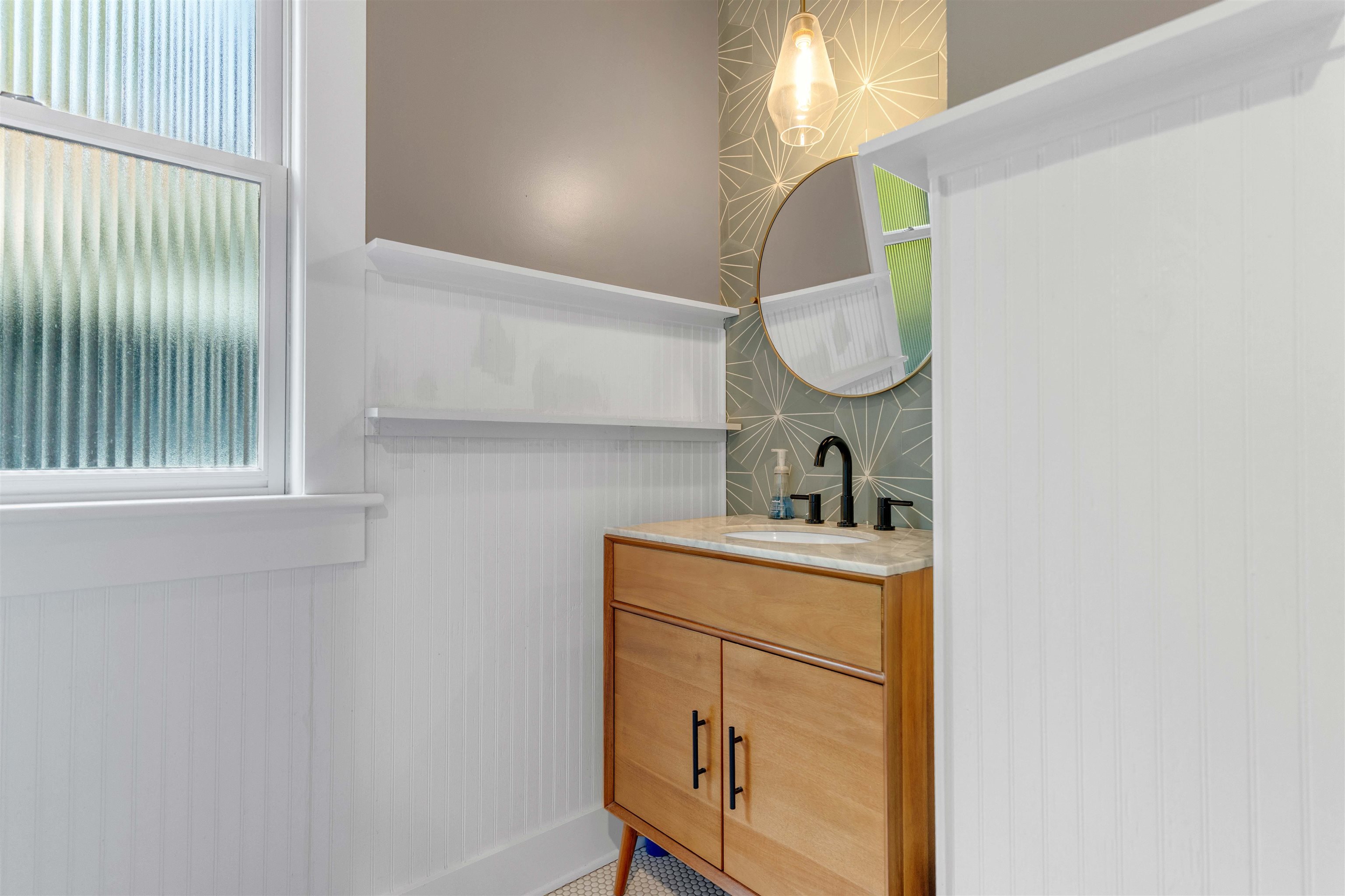 1757 Carruthers Place Memphis, TN 38112 - Photo 24 of 40 a bathroom with a sink vanity and a mirror