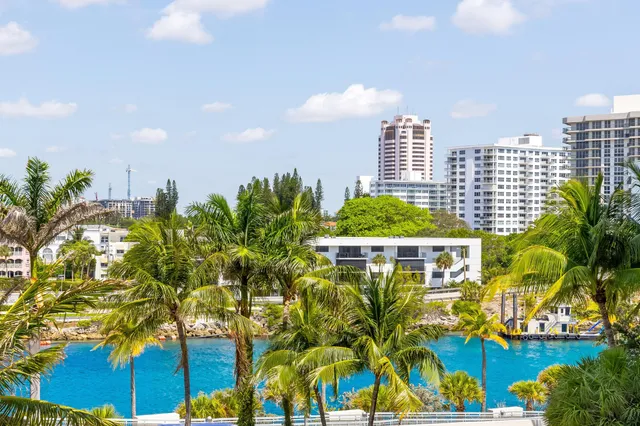 a living room with a bed furniture and a chandelier