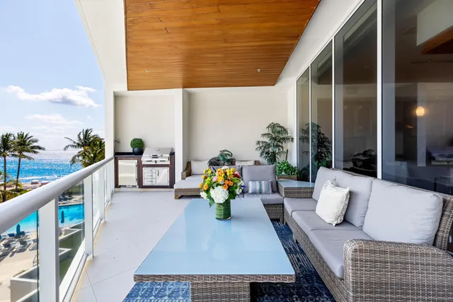 a kitchen with stainless steel appliances granite countertop a stove a sink a dining table and chairs with wooden floor