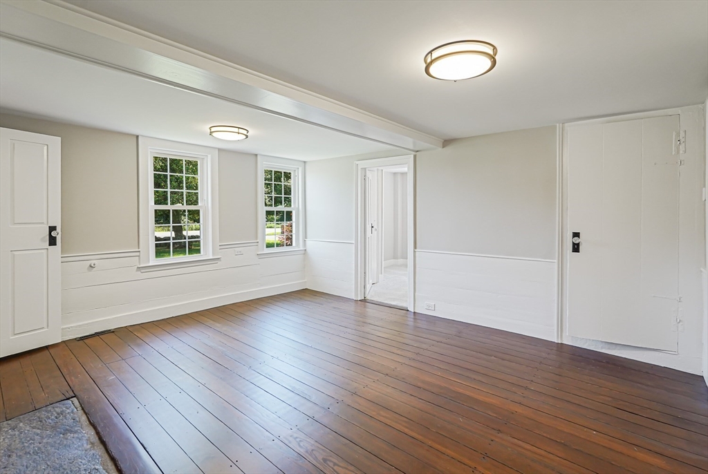 11 Millville Road Mendon, MA 01756 - Photo 11 of 28 a view of an empty room with wooden floor and a window
