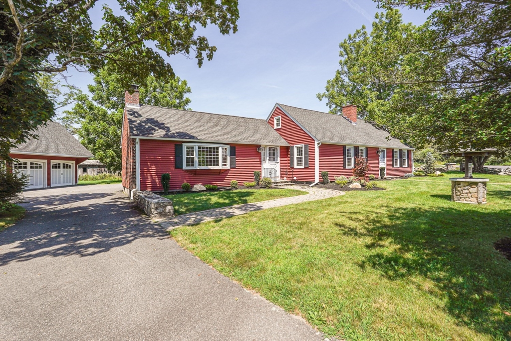 11 Millville Road Mendon, MA 01756 - Photo 2 of 28 a front view of a house with a yard table and chairs