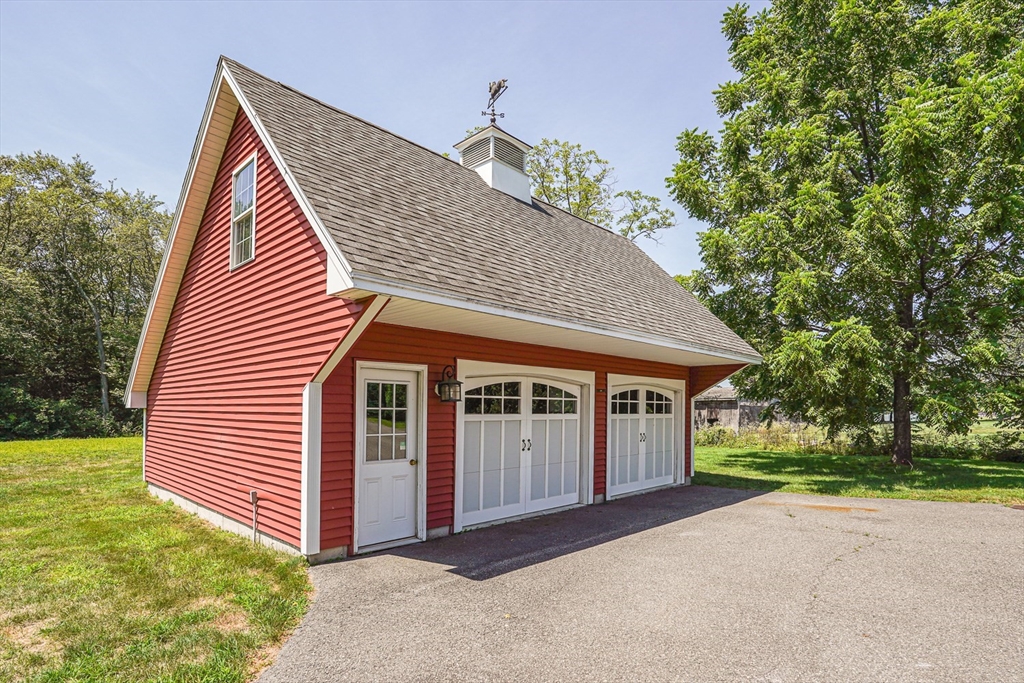 11 Millville Road Mendon, MA 01756 - Photo 3 of 28 a front view of a house with a garden