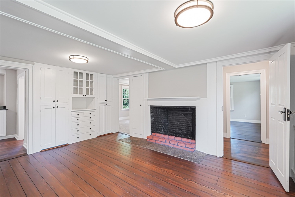 11 Millville Road Mendon, MA 01756 - Photo 8 of 28 a view of empty room with wooden floor and fireplace