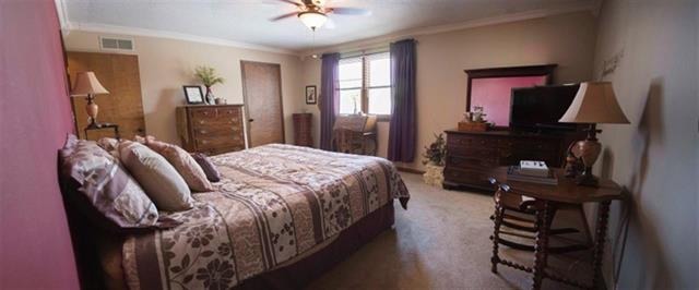 1808 Kelly Road Rock Falls, IL 61071 - Photo 8 of 12 a bedroom with a bed dresser and a flat tv screen