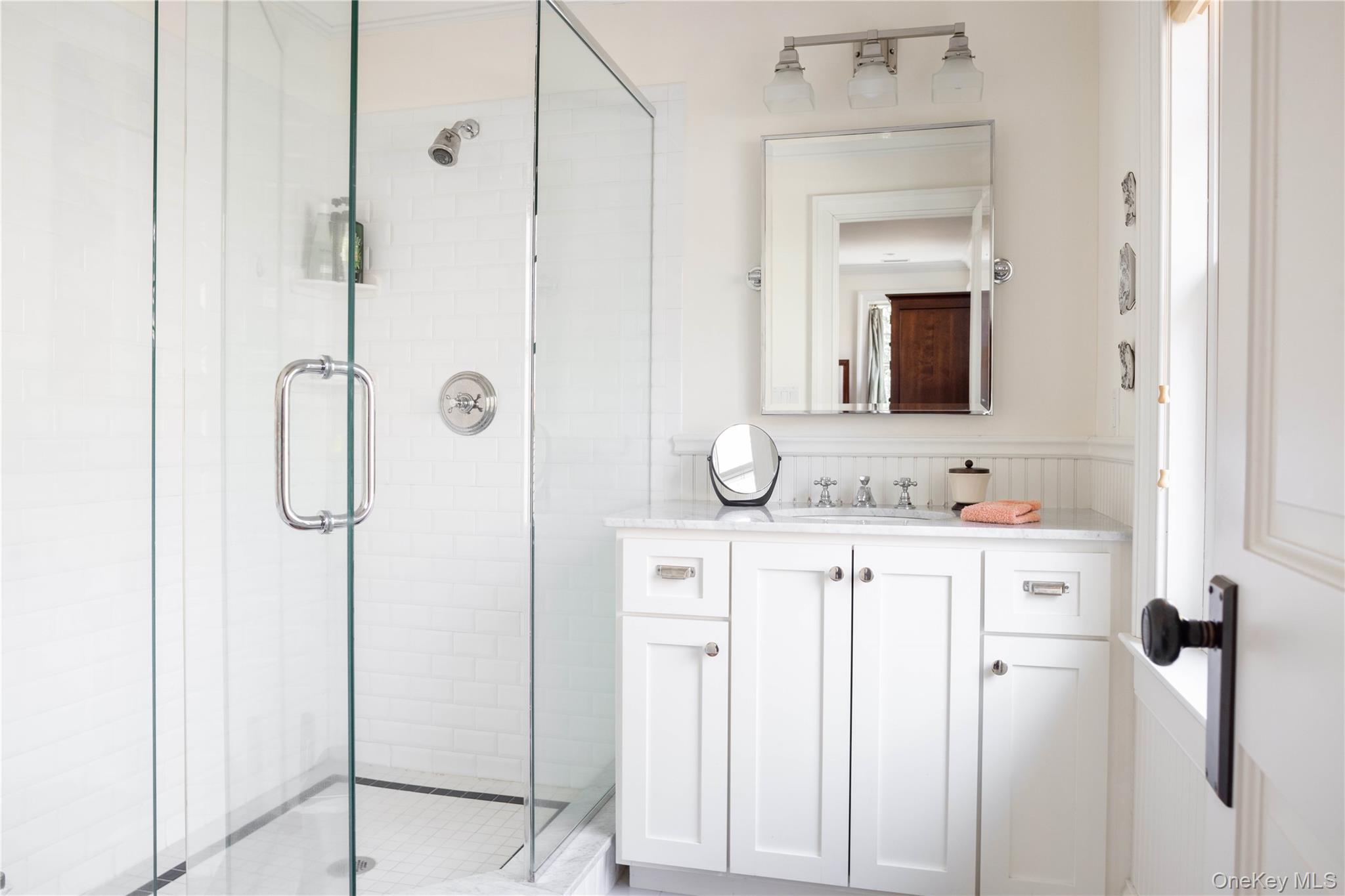 53 Cedar Lane West Remsenburg, NY 11960 - Photo 35 of 38 Bathroom with a wainscoted wall, vanity, and a shower stall
