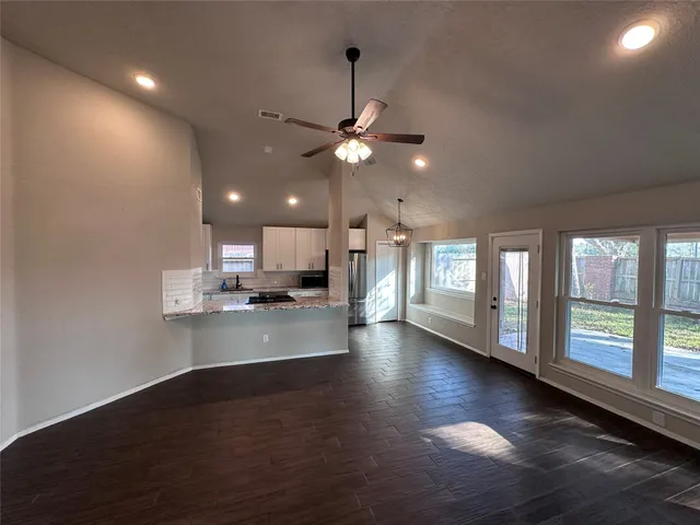a view of a kitchen with a sink and a window