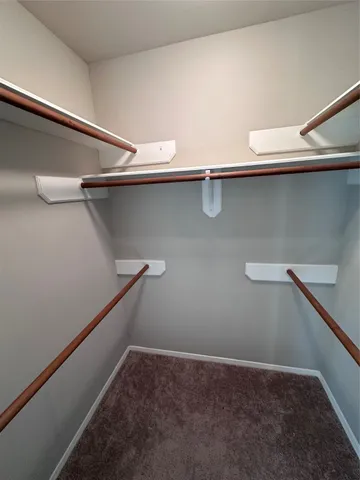 a view of a livingroom with a ceiling fan and window