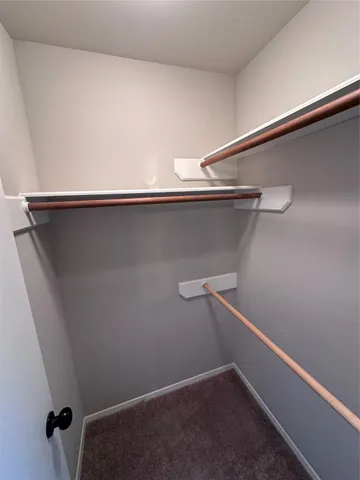 en view of an empty room with a chandelier fan