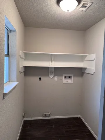 a room with linen closet and wooden floor
