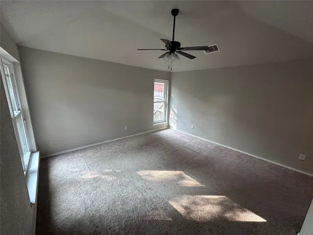 a view of a livingroom with a ceiling fan and window