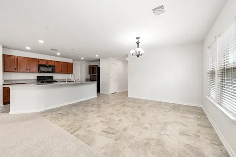 a view of a kitchen with a sink and cabinets