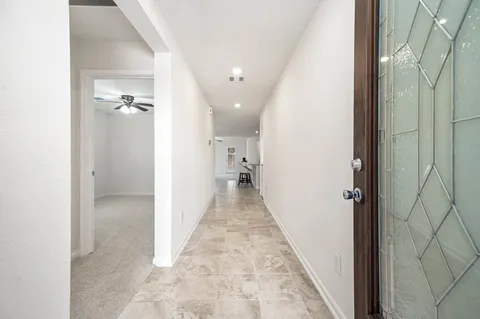 a view of a hallway with closet and wooden floor