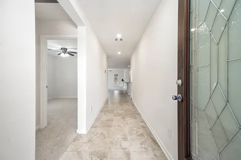 a view of a hallway with closet and wooden floor