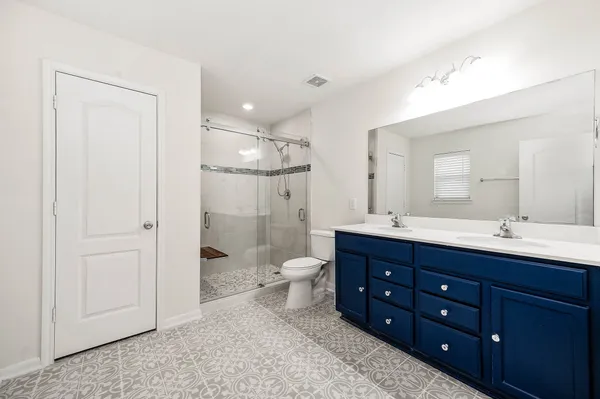 a bathroom with a toilet a sink and a mirror