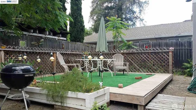 a view of a wooden deck with furniture and a fire pit