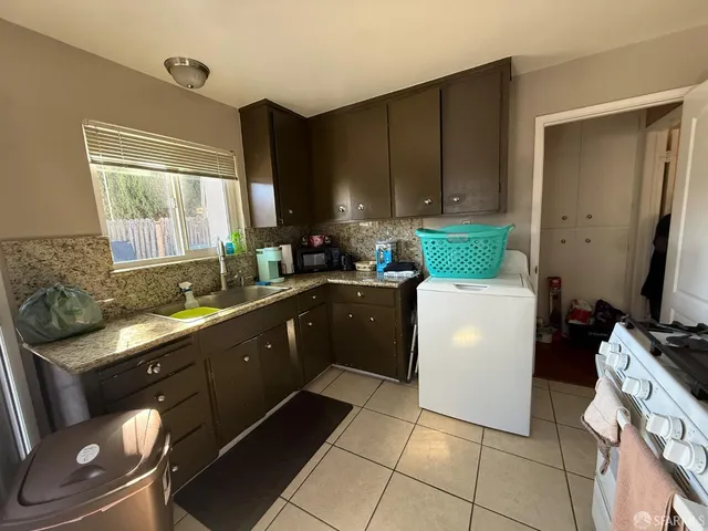 a kitchen with a sink cabinets and window