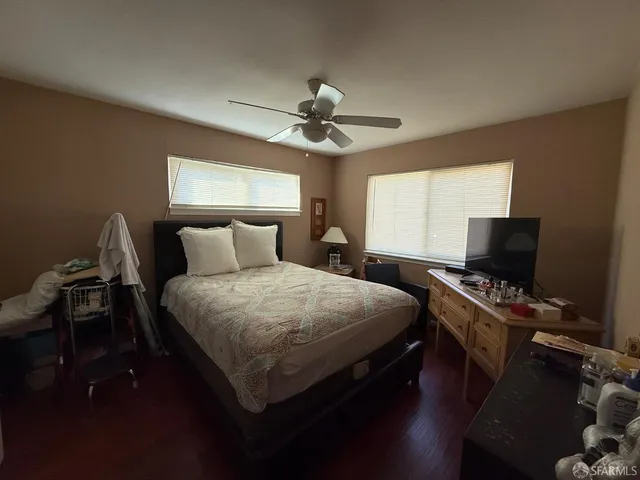 a bedroom with a bed and a flat screen tv