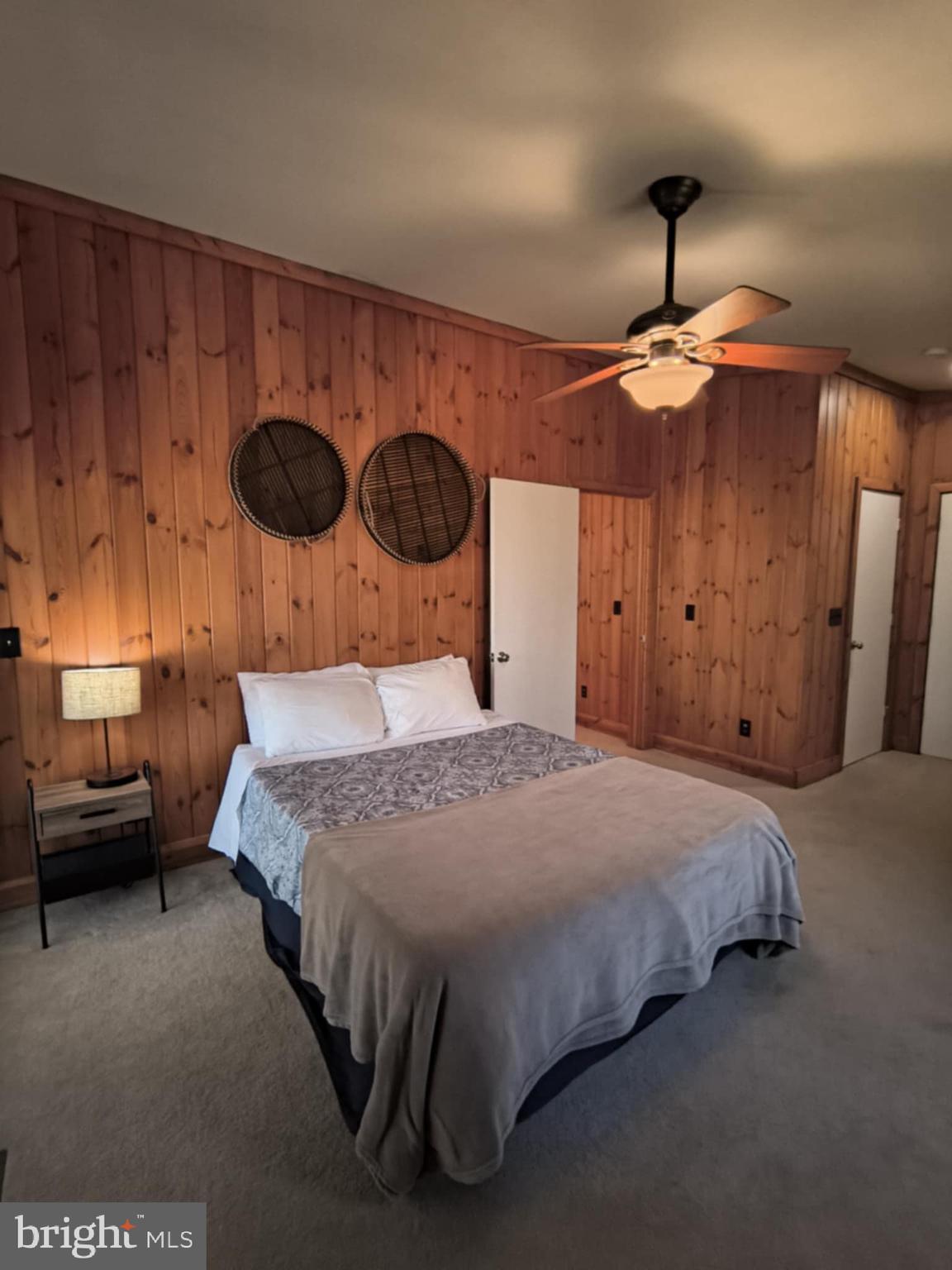202 Constitution Boulevard Locust Grove, VA 22508 - Photo 20 of 36 a bedroom with a bed and a chandelier