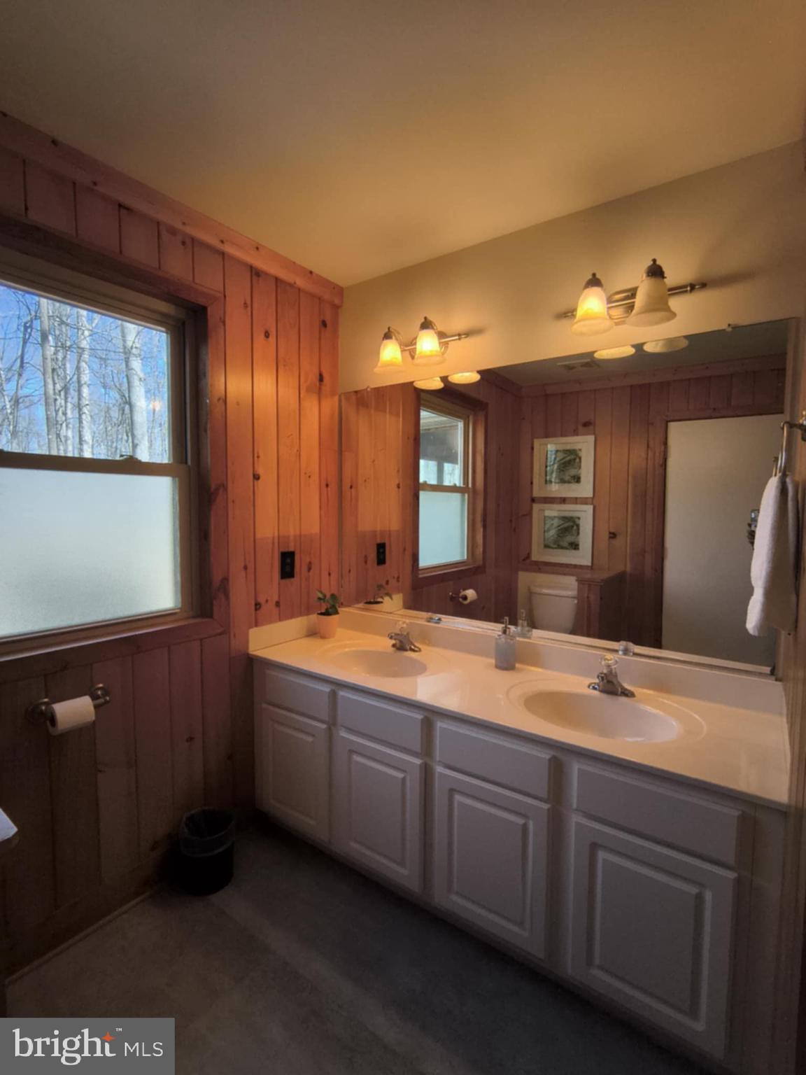 202 Constitution Boulevard Locust Grove, VA 22508 - Photo 22 of 36 a spacious bathroom with a granite countertop sink and a mirror
