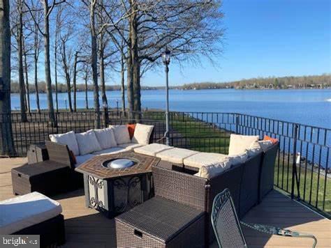 202 Constitution Boulevard Locust Grove, VA 22508 - Photo 33 of 36 a view of a roof deck with couches and wooden floor