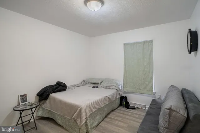 a bedroom with a bed and a chair