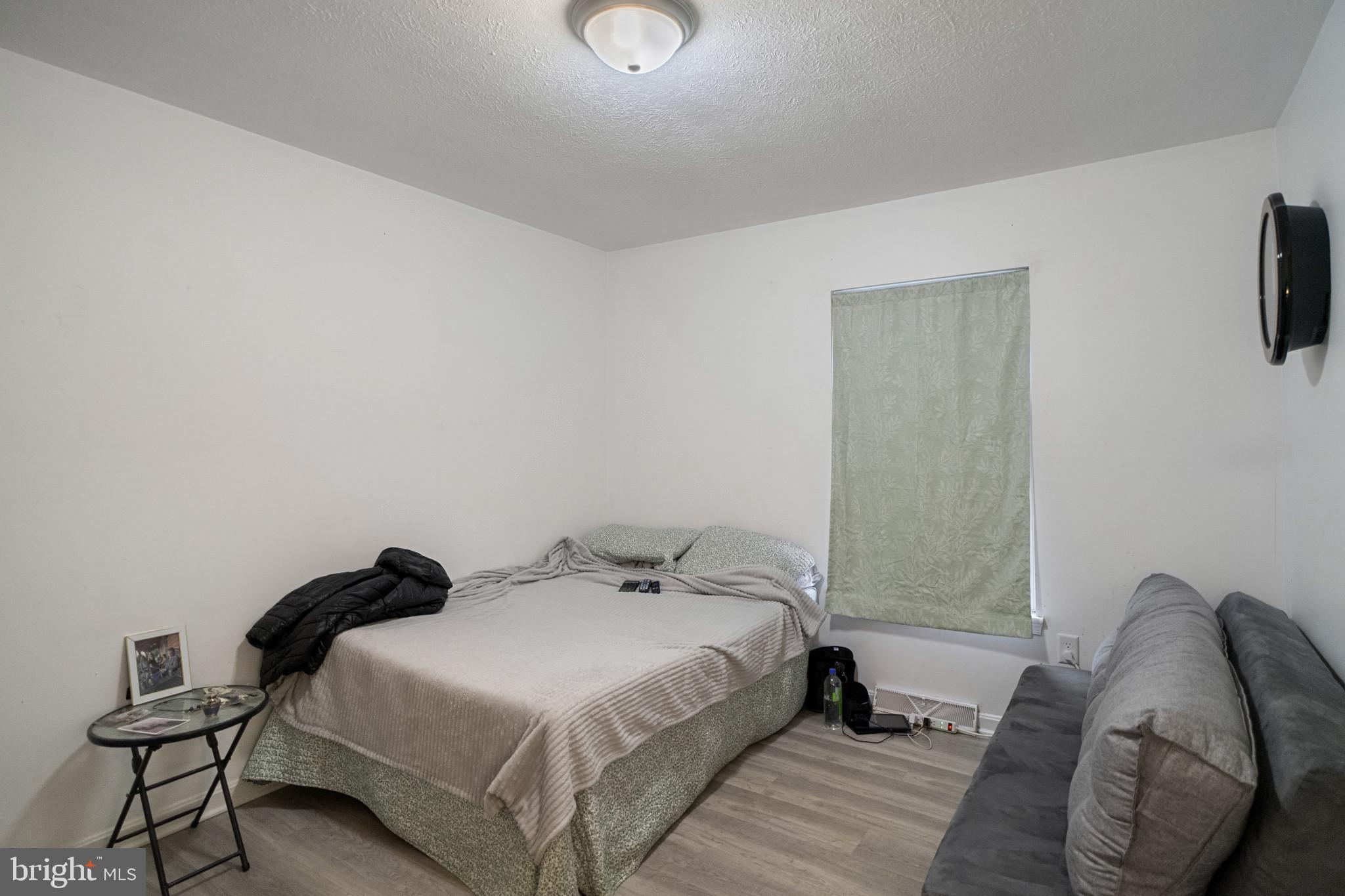 1909 Hanover Pike Hampstead, MD 21074 - Photo 14 of 32 a bedroom with a bed and a chair