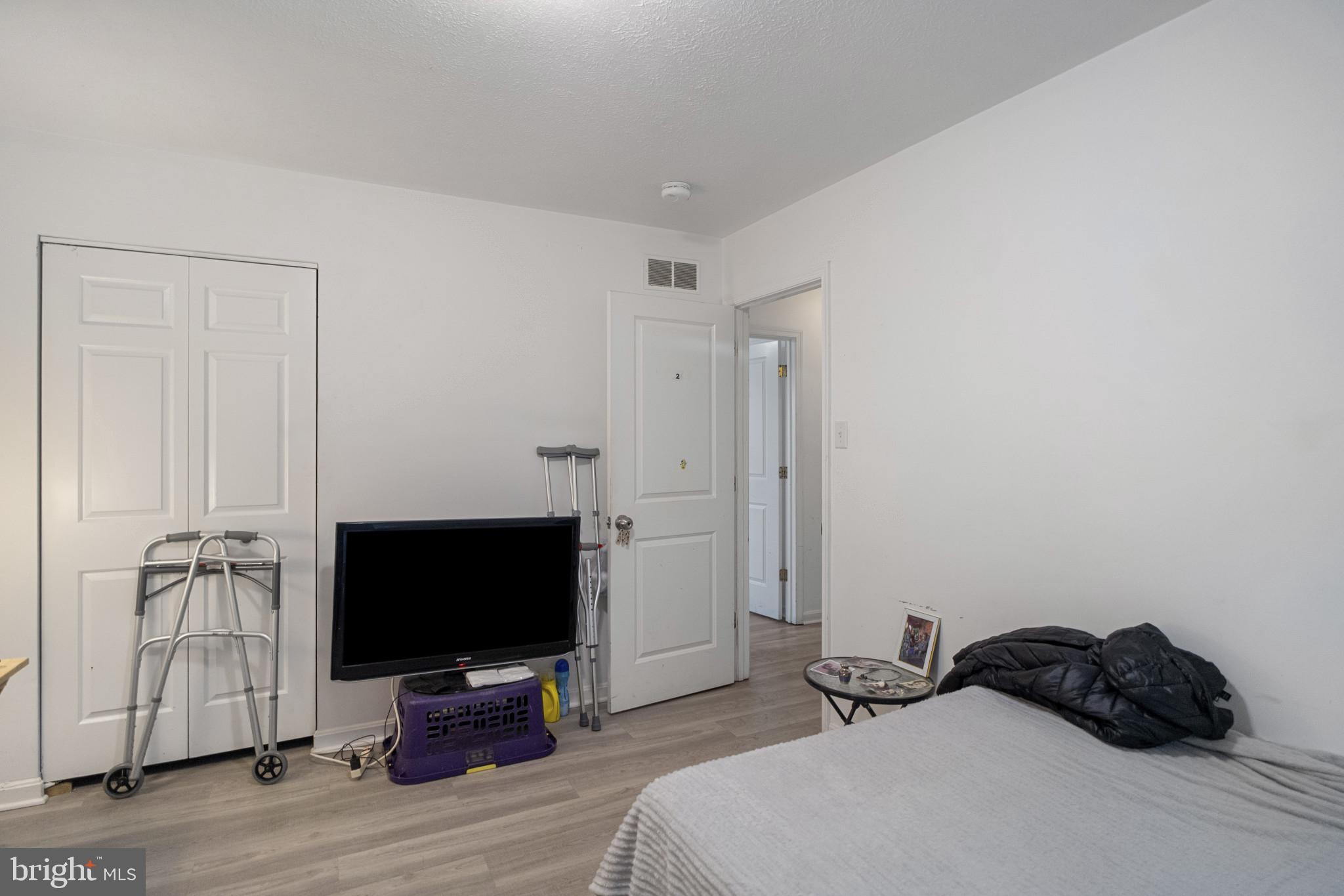 1909 Hanover Pike Hampstead, MD 21074 - Photo 15 of 32 a bedroom with a bed tv and wooden floor
