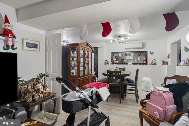 a room with furniture a chandelier and a wooden floor