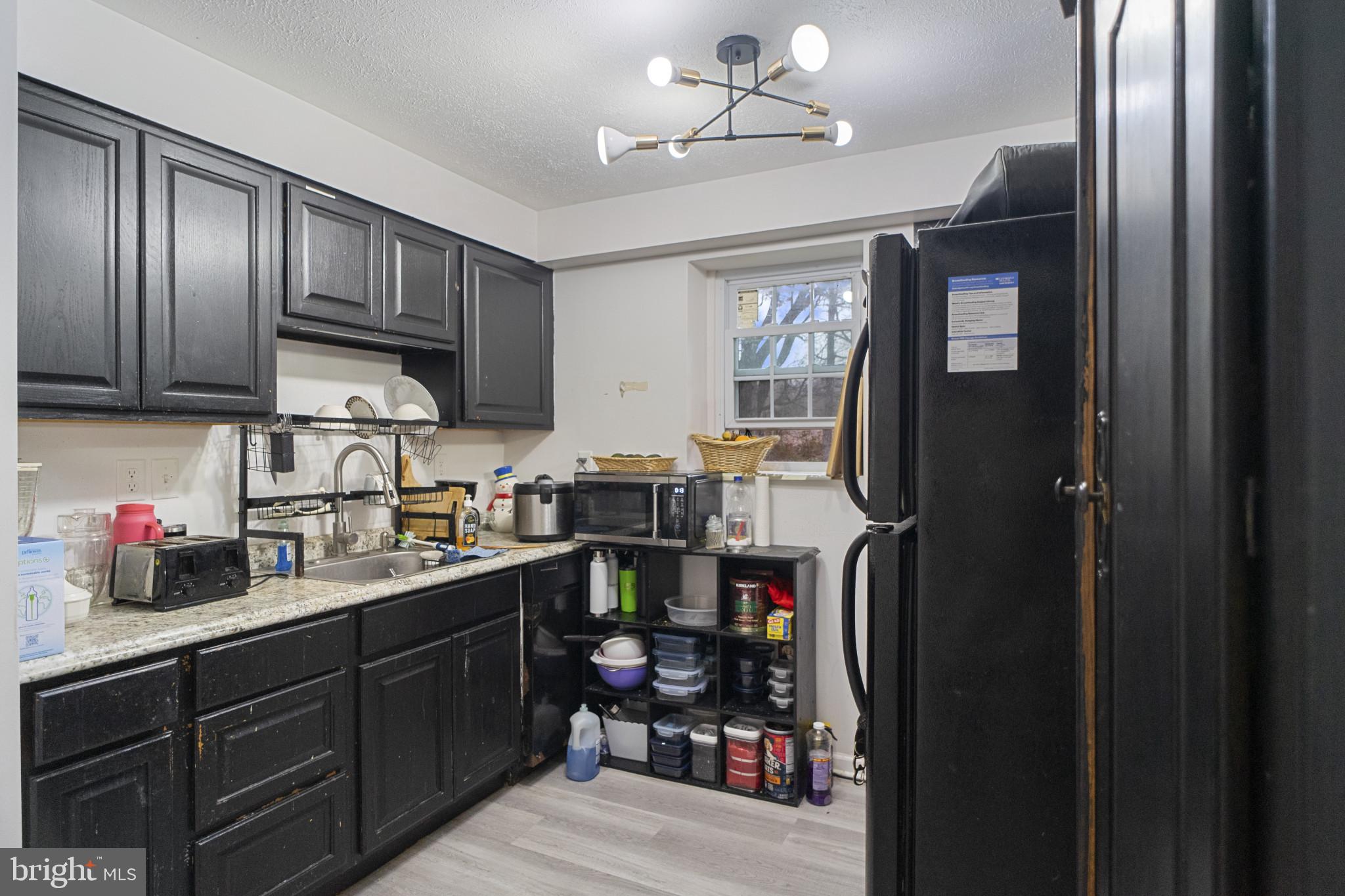 1909 Hanover Pike Hampstead, MD 21074 - Photo 21 of 32 a kitchen with cabinets appliances and a window