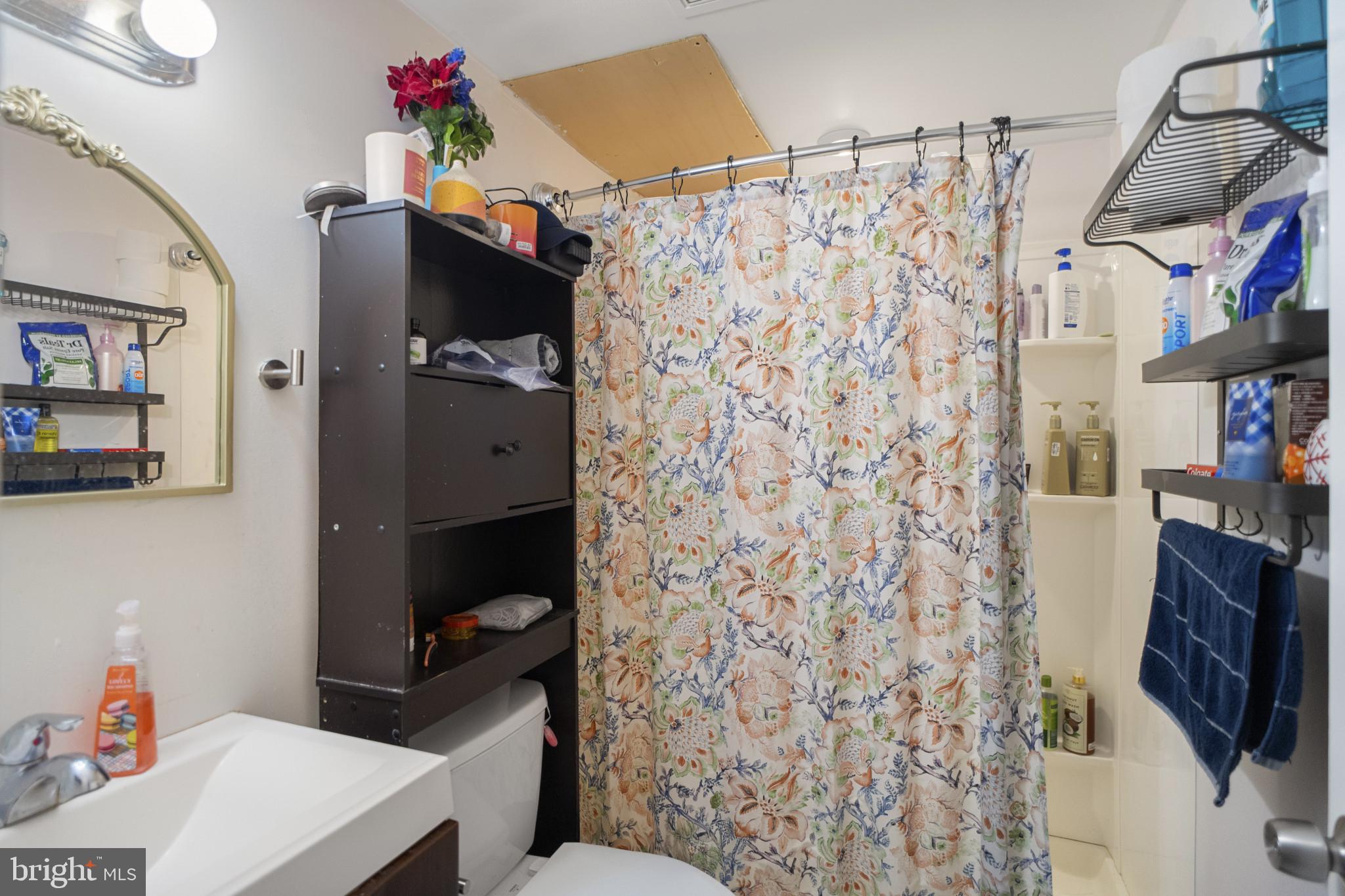 1909 Hanover Pike Hampstead, MD 21074 - Photo 25 of 32 a bathroom with a toilet and a shower curtain
