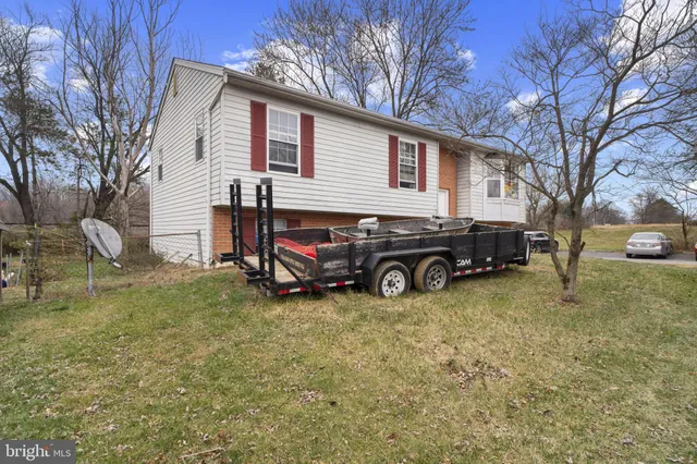 a view of a house with a car parked in front of a house