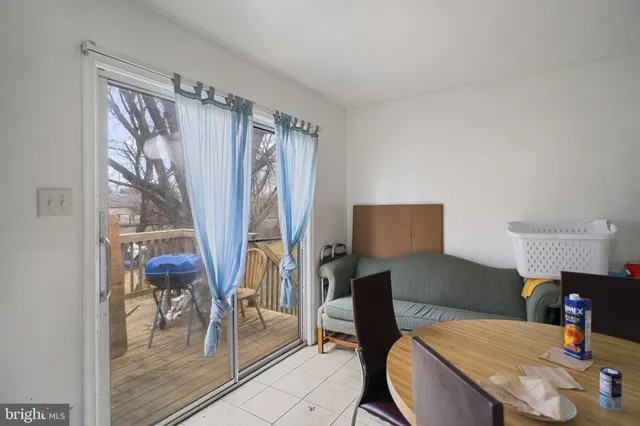 a reading room with furniture a rug and a window