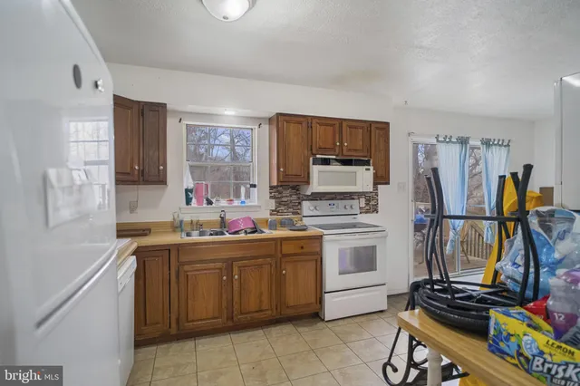 a kitchen with a sink appliances and cabinets