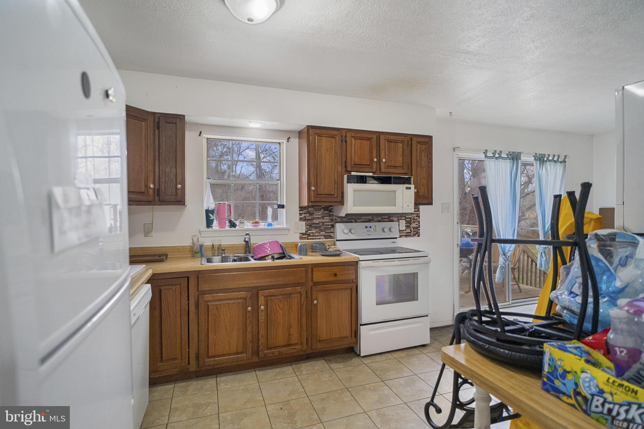 1909 Hanover Pike Hampstead, MD 21074 - Photo 7 of 32 a kitchen with a sink appliances and cabinets