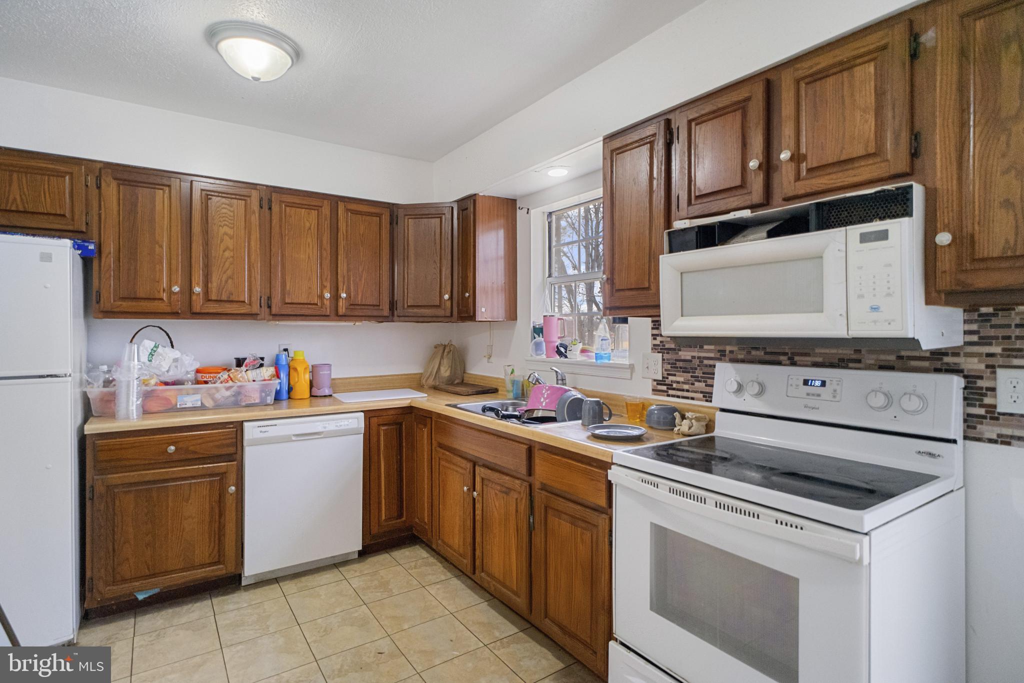 1909 Hanover Pike Hampstead, MD 21074 - Photo 8 of 32 a kitchen with a sink stove top oven and cabinets