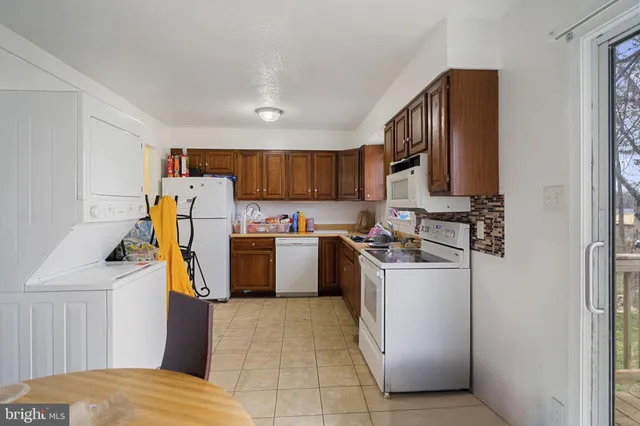 a kitchen with a refrigerator and a stove