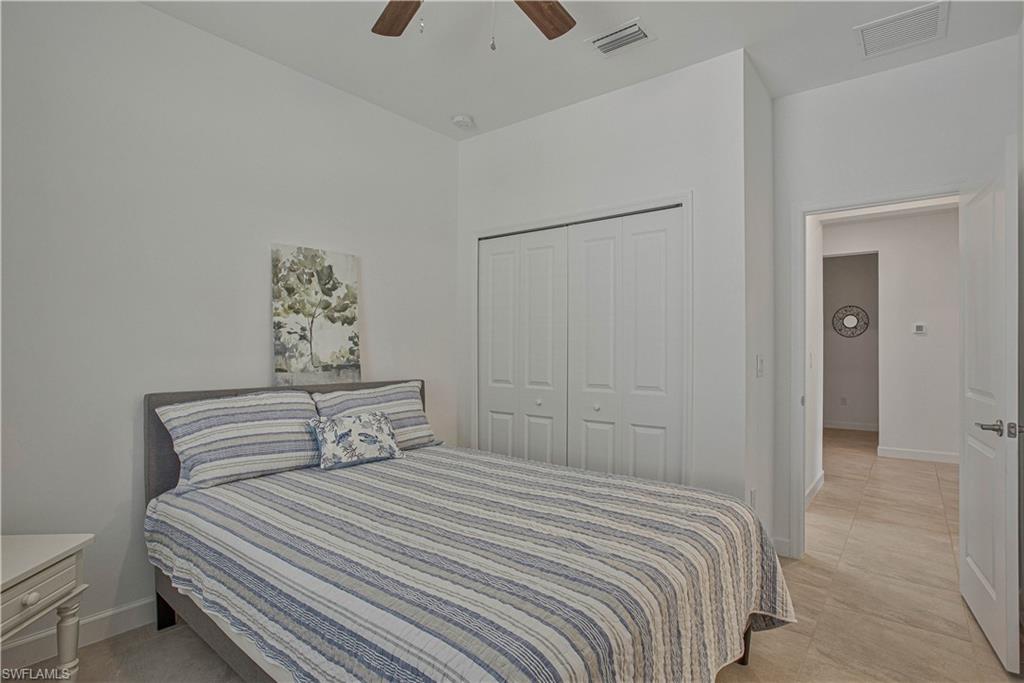 18293 Ridgeline Drive Estero, FL 33928 - Photo 13 of 47 a bedroom with a bed and a painting on the wall